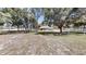 Backyard featuring a screened-in patio, a lush lawn, and mature trees, creating a peaceful and private outdoor space at 10528 Sw 27Th Ave, Ocala, FL 34476