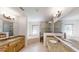 Spacious bathroom with a walk-in shower, tub, dual sinks, and granite countertops at 10528 Sw 27Th Ave, Ocala, FL 34476
