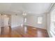 Bright primary bedroom with hardwood floors and windows overlooking a green landscape at 10528 Sw 27Th Ave, Ocala, FL 34476