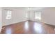 Bright bedroom with hardwood floors and sunlit windows overlooking scenic greenery at 10528 Sw 27Th Ave, Ocala, FL 34476