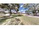 Spacious home with a three-car garage, well-maintained lawn, and mature trees surrounding the property at 10528 Sw 27Th Ave, Ocala, FL 34476