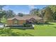 Charming single-story home with stone accents, a well-manicured lawn, and lush landscaping at 10528 Sw 27Th Ave, Ocala, FL 34476