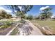 Beautiful brick walkway leading to a charming single-story home with mature landscaping and a well-manicured lawn at 10528 Sw 27Th Ave, Ocala, FL 34476