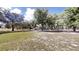 Spacious front yard with mature trees and white fencing, offering a serene and private setting at 10528 Sw 27Th Ave, Ocala, FL 34476