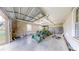 Tractor and lawn maintenance equipment is organized inside of a detached, three-car garage at 10528 Sw 27Th Ave, Ocala, FL 34476