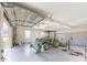 Tractor and lawn maintenance equipment is organized inside of a detached, three-car garage at 10528 Sw 27Th Ave, Ocala, FL 34476