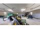 Inside of a three-car garage with lawn maintenance equipment and trailers at 10528 Sw 27Th Ave, Ocala, FL 34476