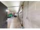 Wide shot of tractor and lawn maintenance equipment stored inside of detached garage at 10528 Sw 27Th Ave, Ocala, FL 34476