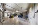 Spacious garage with concrete block walls, multiple vehicles and equipment, and bright overhead lighting at 10528 Sw 27Th Ave, Ocala, FL 34476