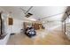 Large garage featuring storage cabinets, recessed lights and a golf cart parking space at 10528 Sw 27Th Ave, Ocala, FL 34476