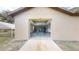 Attached garage entrance showing tractor and equipment with concrete flooring and block walls at 10528 Sw 27Th Ave, Ocala, FL 34476