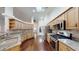 Bright open kitchen with stainless steel appliances, wood cabinets, granite countertops and view of living area at 10528 Sw 27Th Ave, Ocala, FL 34476
