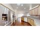 Bright kitchen with stainless steel appliances, wood cabinets, granite countertops, and dark wood floors at 10528 Sw 27Th Ave, Ocala, FL 34476