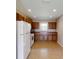 Cozy kitchen featuring tile floors, wooden cabinets, and essential white appliances at 10528 Sw 27Th Ave, Ocala, FL 34476