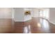 Open-concept floor plan with hardwood floors and a view of the kitchen at 10528 Sw 27Th Ave, Ocala, FL 34476