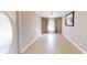 Bright, open living room with tile flooring, neutral walls and a front entry view at 10528 Sw 27Th Ave, Ocala, FL 34476