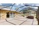Spacious screened patio with brick flooring, hot tub, and access to indoor living spaces at 10528 Sw 27Th Ave, Ocala, FL 34476