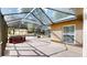 Large, screened patio with hot tub and brick flooring provides ample space for outdoor living at 10528 Sw 27Th Ave, Ocala, FL 34476