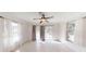 Bright sun room with tiled floor, ceiling fan and sliding doors to backyard at 10528 Sw 27Th Ave, Ocala, FL 34476
