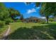 The backyard features a screened-in pool area, lush green grass and mature landscaping at 11586 Sw 75Th Cir, Ocala, FL 34476