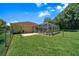 Expansive backyard with lush green grass and a screened-in pool area, offering privacy and outdoor enjoyment at 11586 Sw 75Th Cir, Ocala, FL 34476