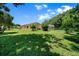 Expansive backyard featuring lush green grass and mature trees surrounding the property at 11586 Sw 75Th Cir, Ocala, FL 34476
