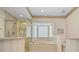 Bright bathroom with a large soaking tub, a separate glass-enclosed shower, and neutral decor at 11586 Sw 75Th Cir, Ocala, FL 34476