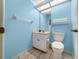Powder room featuring blue walls, tile floors, and white fixtures at 11586 Sw 75Th Cir, Ocala, FL 34476