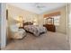 Spacious bedroom with carpet flooring, ceiling fan, and a large window for natural light at 11586 Sw 75Th Cir, Ocala, FL 34476