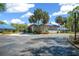 Exterior of the community's Orchid Club showing palm trees and a sidewalk at 11586 Sw 75Th Cir, Ocala, FL 34476