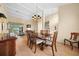 Dining room with wood table and chairs, chandelier, and neutral tones at 11586 Sw 75Th Cir, Ocala, FL 34476