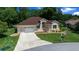 Charming home with well-manicured lawn, inviting curb appeal and a two-car garage at 11586 Sw 75Th Cir, Ocala, FL 34476