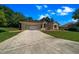 Attractive single-story house with an attached garage and a long concrete driveway at 11586 Sw 75Th Cir, Ocala, FL 34476