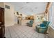 Bright Florida room with tile floors, ceiling fan, and comfortable seating at 11586 Sw 75Th Cir, Ocala, FL 34476