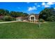 Inviting single-story home with lush green lawn, mature trees, and attached two-car garage at 11586 Sw 75Th Cir, Ocala, FL 34476