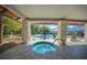 Outdoor hot tub featuring stone columns and a wood ceiling in a community pool area at 11586 Sw 75Th Cir, Ocala, FL 34476