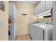 Well-equipped laundry room with washer, dryer, and ample cabinet space for storage at 11586 Sw 75Th Cir, Ocala, FL 34476