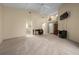 Spacious living room featuring high ceilings, neutral carpeting, and adjacent home office space at 11586 Sw 75Th Cir, Ocala, FL 34476