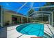 Sparkling in-ground pool surrounded by a screened enclosure, creating a serene and private retreat at 11586 Sw 75Th Cir, Ocala, FL 34476