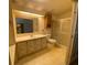 Well-lit bathroom featuring a vanity, mirror, and shower at 1408 Torrey Pines Dr, Lady Lake, FL 32159