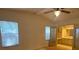 Bedroom features ceiling fan, natural light, and attached bathroom at 1408 Torrey Pines Dr, Lady Lake, FL 32159