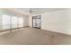 Large bedroom with neutral carpeting, sliding glass door, and ample natural light at 1408 Torrey Pines Dr, Lady Lake, FL 32159