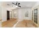 Bare bedroom features a ceiling fan, neutral walls and flooring, closet, and French doors to the exterior at 1408 Torrey Pines Dr, Lady Lake, FL 32159