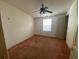 Bedroom features ceiling fan, natural light, and a neutral color palette at 1408 Torrey Pines Dr, Lady Lake, FL 32159