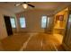 Spacious bedroom with a ceiling fan, windows, and bathroom entrance at 1408 Torrey Pines Dr, Lady Lake, FL 32159