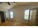 Bedroom features ceiling fan, natural light, and a mirrored closet at 1408 Torrey Pines Dr, Lady Lake, FL 32159
