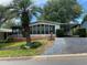 Charming single story home with a carport, a palm tree, and a well-maintained yard at 1408 Torrey Pines Dr, Lady Lake, FL 32159