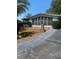 Inviting single-story home featuring a large windowed sunroom and well-maintained front yard at 1408 Torrey Pines Dr, Lady Lake, FL 32159