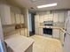 Functional kitchen with white cabinets and standard appliances offers a practical cooking space at 1408 Torrey Pines Dr, Lady Lake, FL 32159