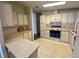 Vintage kitchen featuring classic cabinetry, stove, and ample counter space at 1408 Torrey Pines Dr, Lady Lake, FL 32159